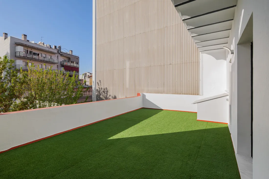 Artificial turf laid in a small enclosed courtyard